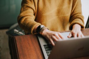 Person working remotely as a virtual assistant on a laptop.